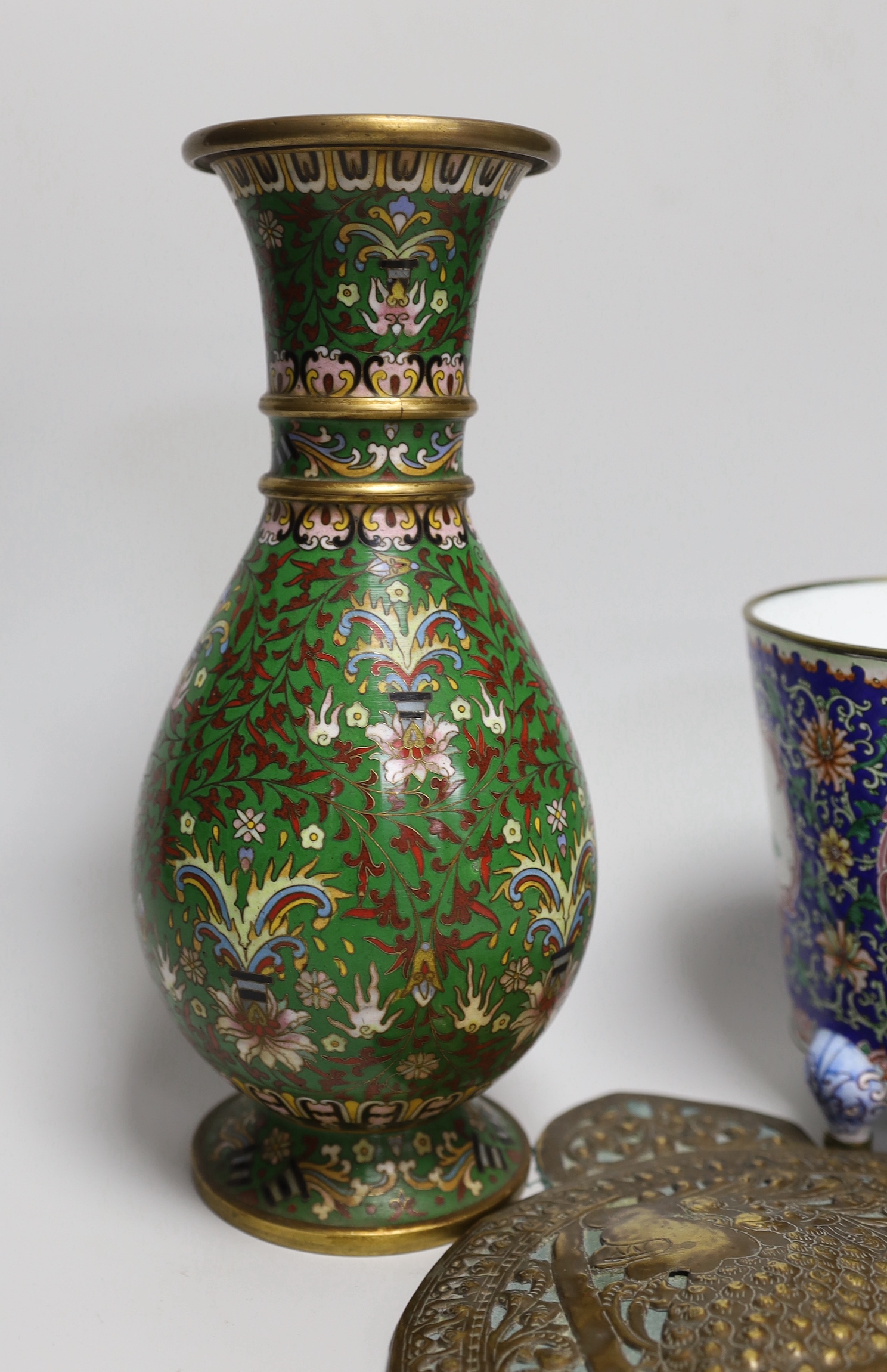 A Chinese Guangzhou enamel vase, a cloisonné enamel vase and an Indonesian brass panel, tallest 26cm high